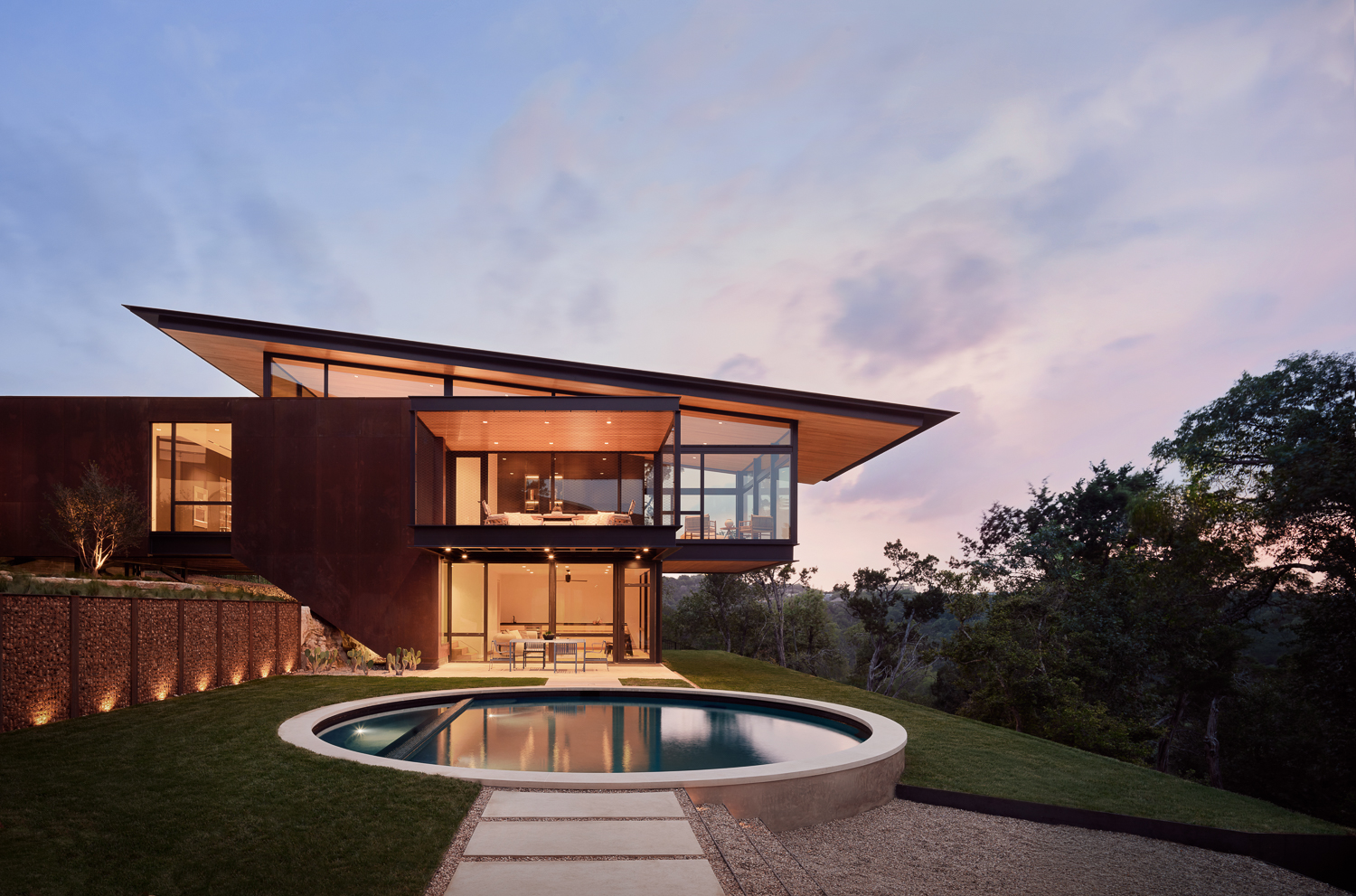 How to Buy a Luxury Home in Austin: The 2026 Buyer's Guide Luxury Austin hillside estate at dusk overlooking the Texas Hill Country