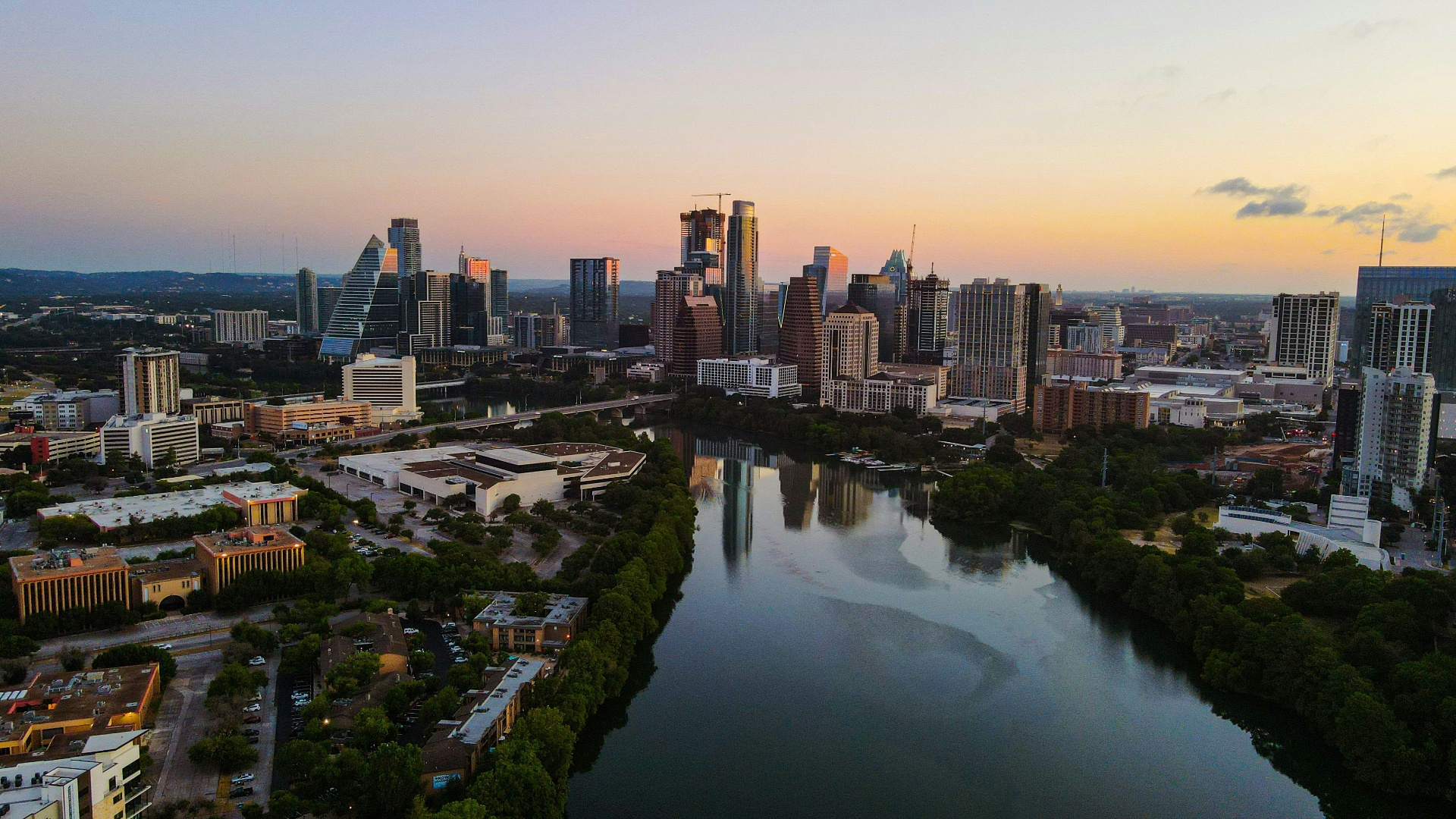 Austin Housing Market Update, June 2026: The Turn Is Finally Here Aerial view of the Austin, Texas downtown skyline at sunset with Lady Bird Lake reflecting the city