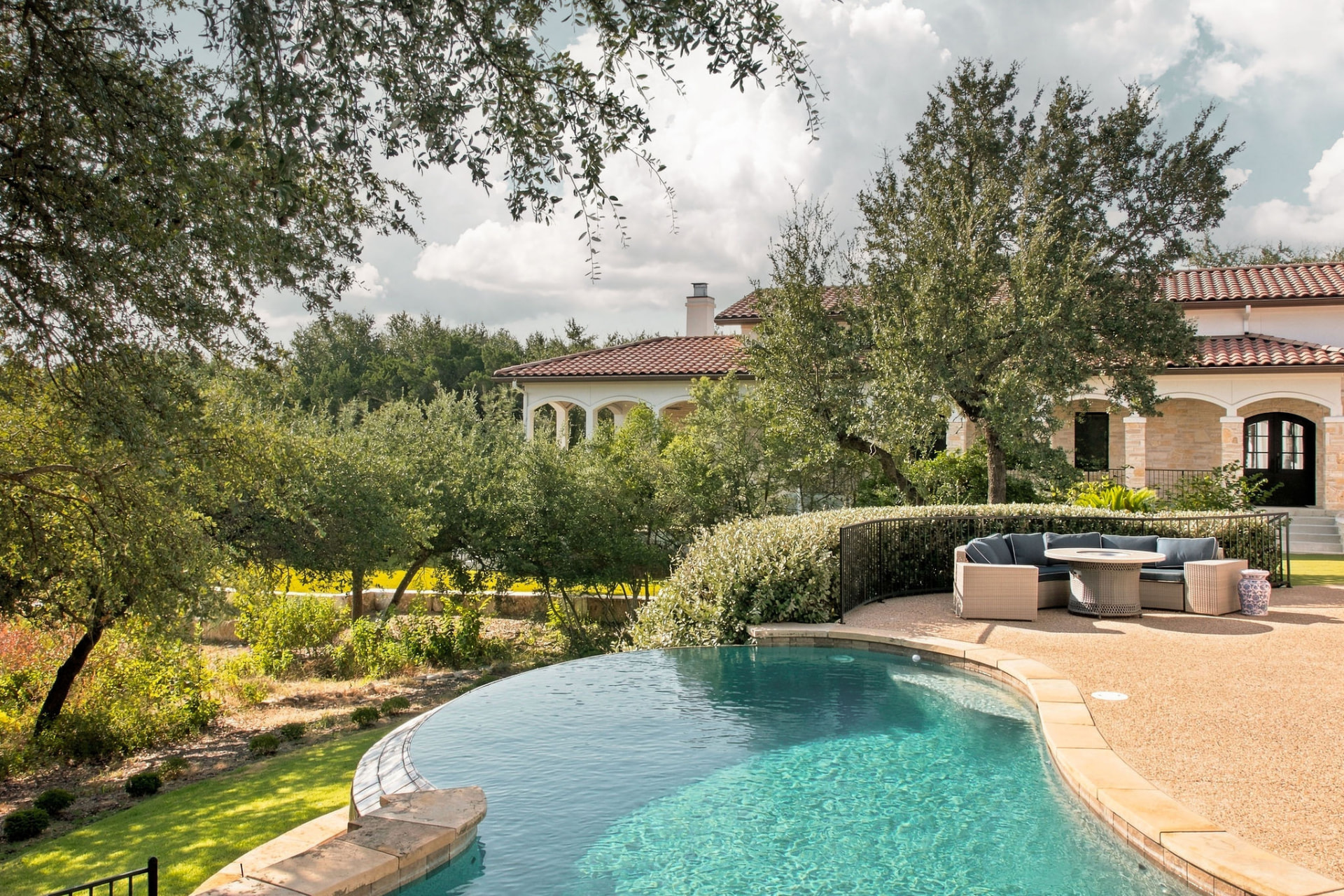 The Best Time to Sell a House in Austin: 36 Months of Contract Data, and Why Luxury Runs on a Different Calendar Infinity-edge pool and stone terrace behind a Mediterranean-style West Austin estate framed by live oaks