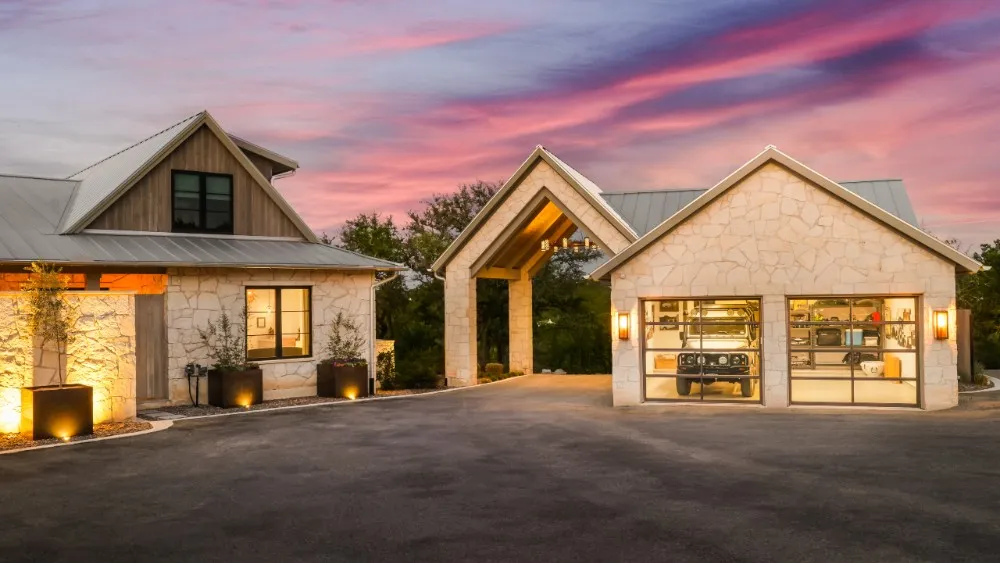 Privacy Concerns When Selling a High-Value Home: What Sellers Need to Know Gated Austin luxury estate at dusk with stone facade, standing-seam metal roof, and lit motor court