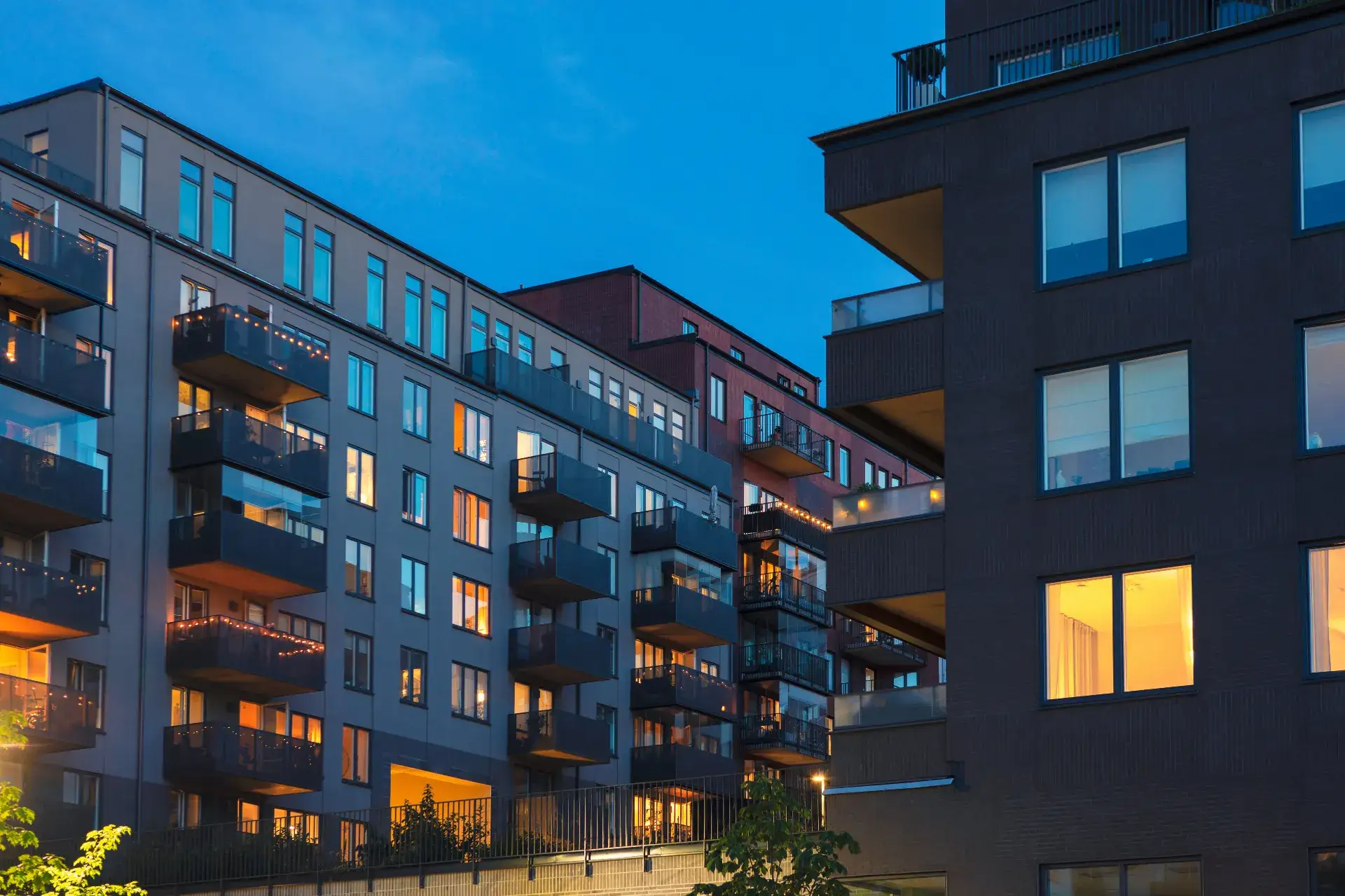 Austin multifamily investment property at dusk with lit balconies and modern architecture